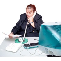 Photo of woman sitting at desk talking on phone,