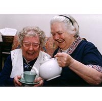 Photo of two older woman having a cup of tea