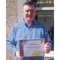 Photo of Martin with certificate